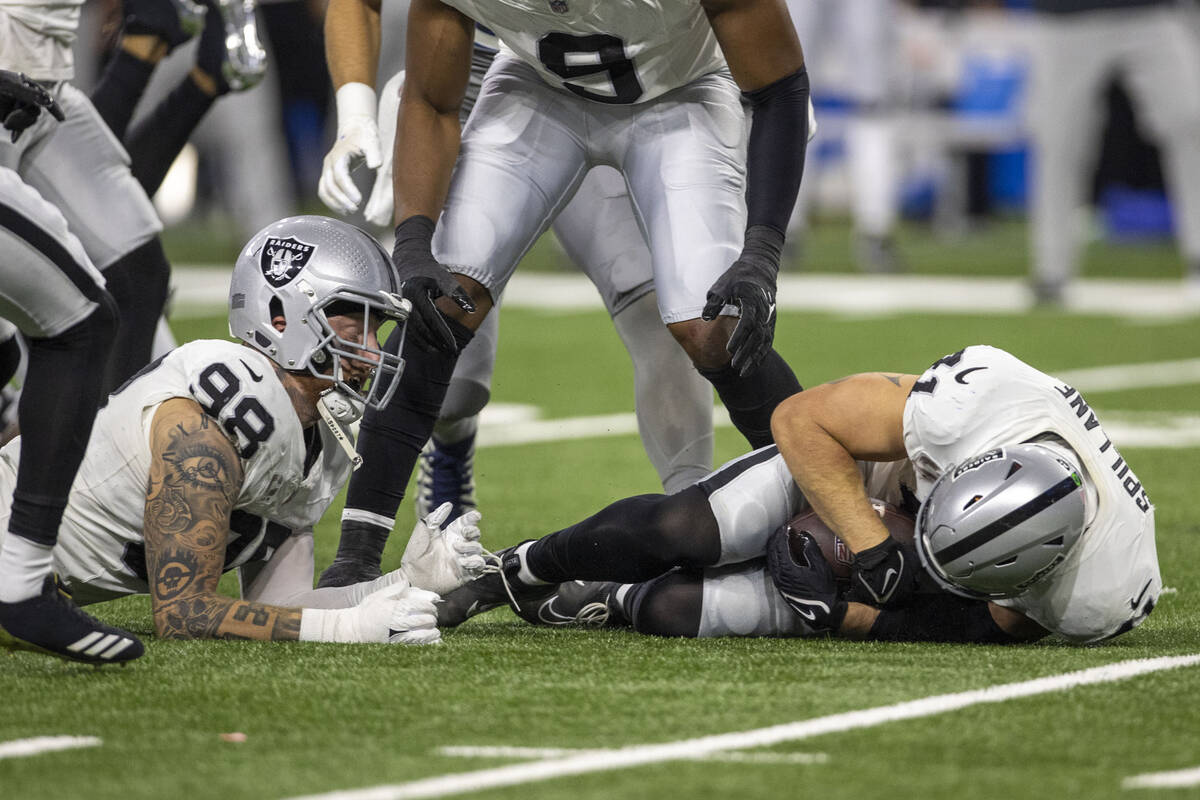 Raiders linebacker Robert Spillane (41) recovers a fumble by Detroit Lions wide receiver Josh R ...