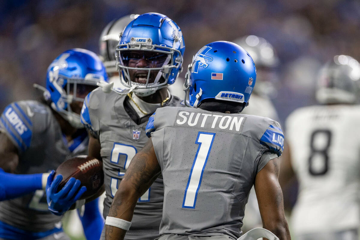 Detroit Lions safety Kerby Joseph (31) celebrates with cornerback Cameron Sutton (1) after int ...