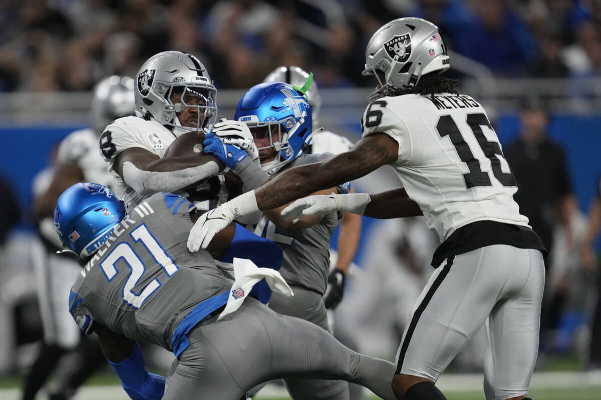 Las Vegas Raiders running back Josh Jacobs (8) is tackled by Detroit Lions safety Tracy Walker ...