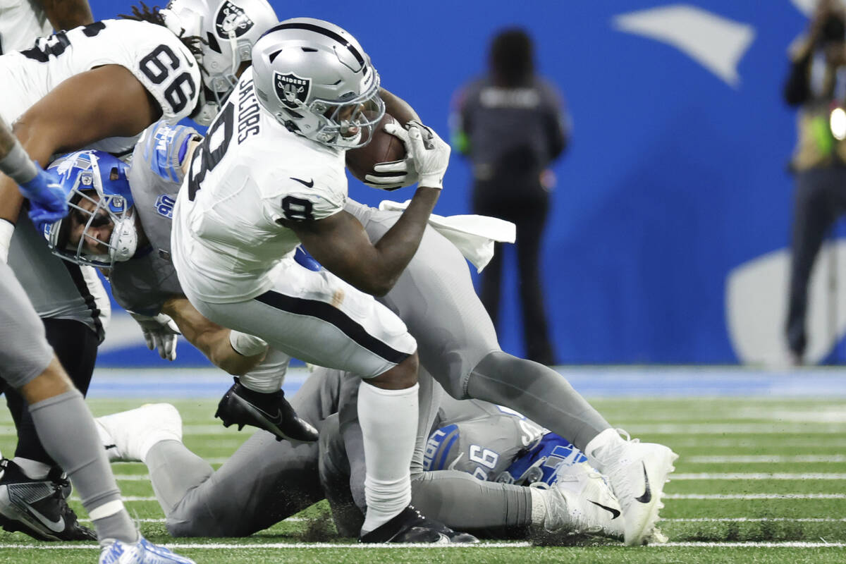 Las Vegas Raiders running back Josh Jacobs (8) is tackled by Detroit Lions defensive end Aidan ...