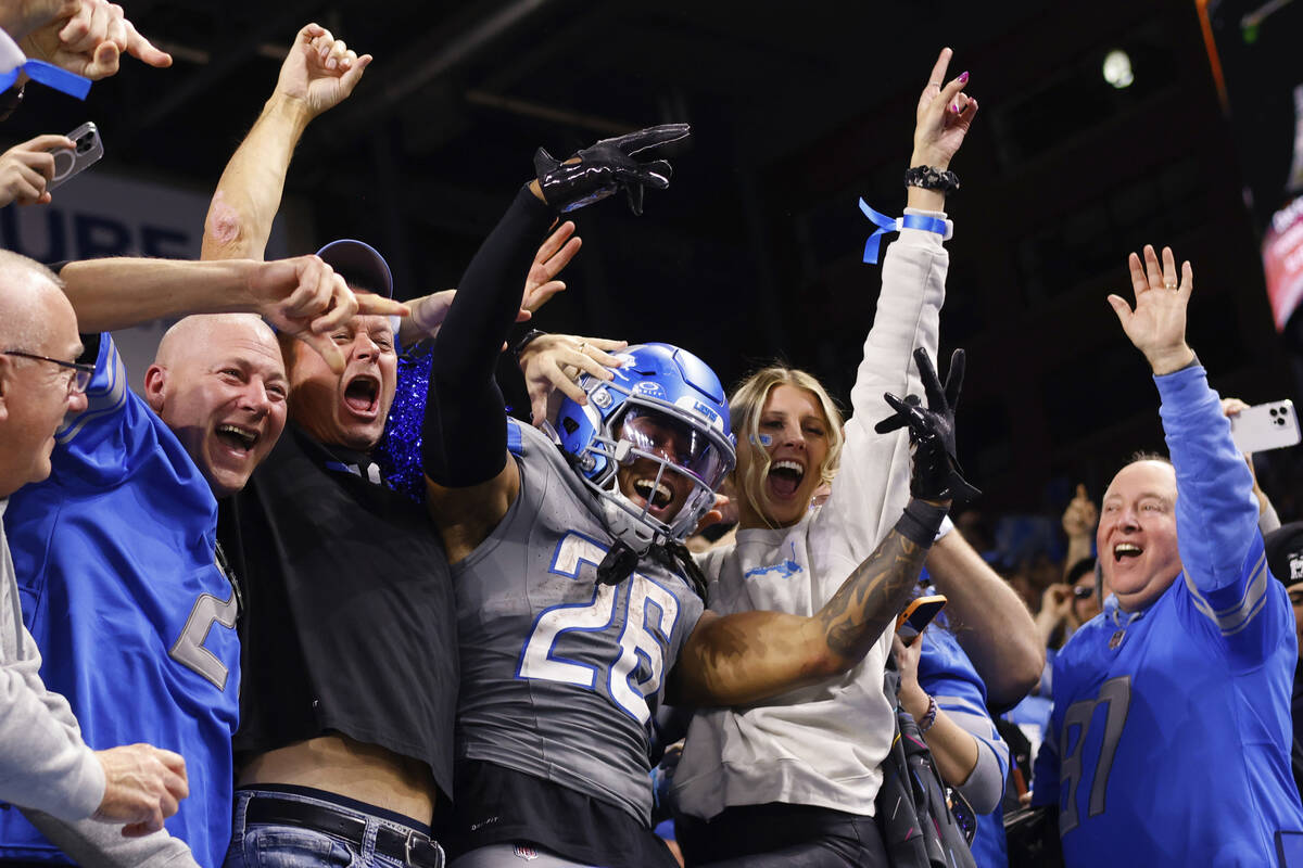Detroit Lions running back Jahmyr Gibbs (26) celebrates with fans after scoring a touchdown aga ...