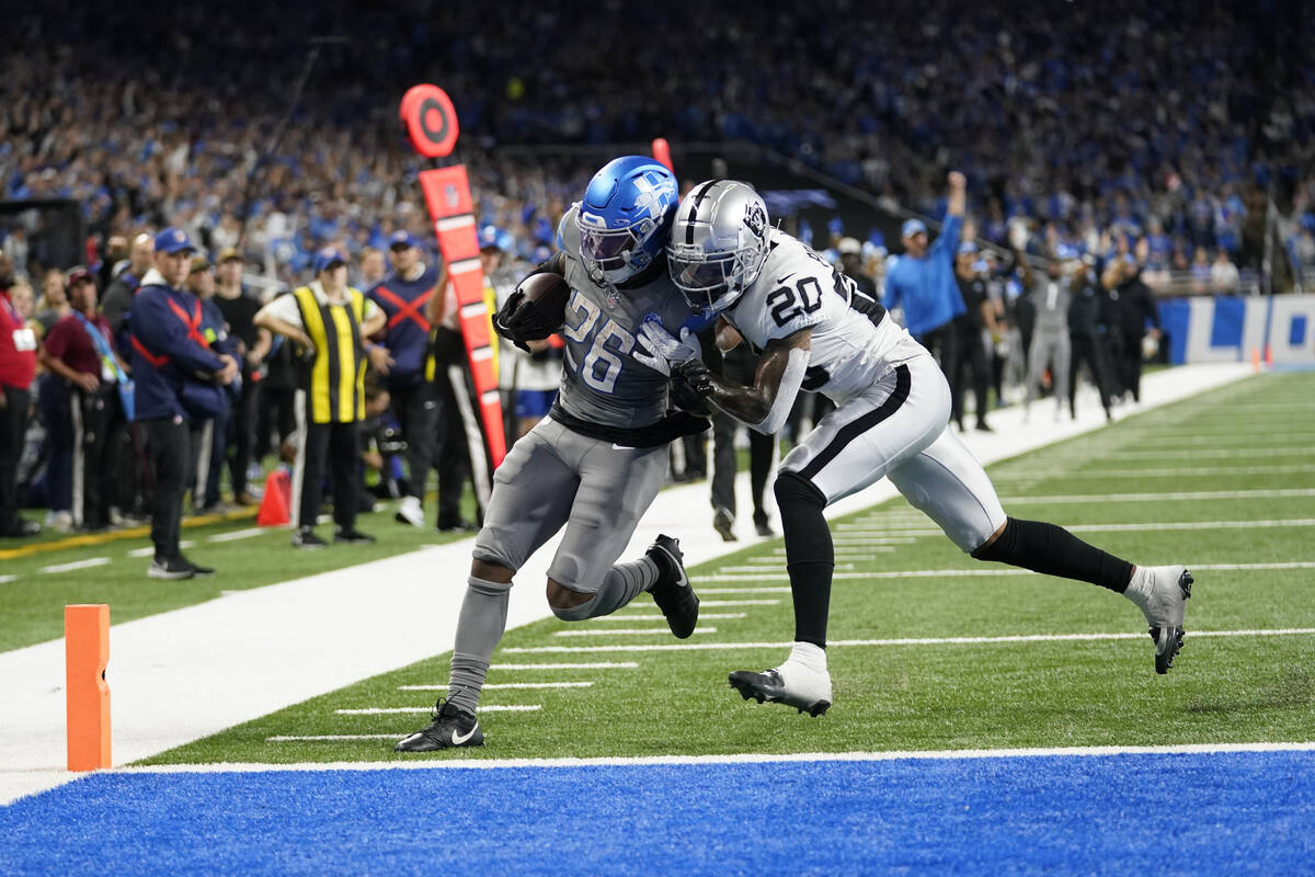 Detroit Lions running back Jahmyr Gibbs (26) is pushed out of bounds by Las Vegas Raiders safet ...