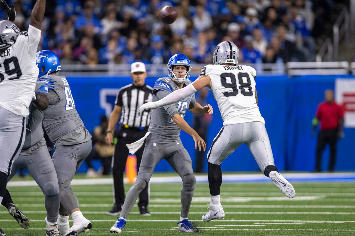 Raiders defensive end Maxx Crosby (98) puts pressure on Detroit Lions quarterback Jared Goff (1 ...