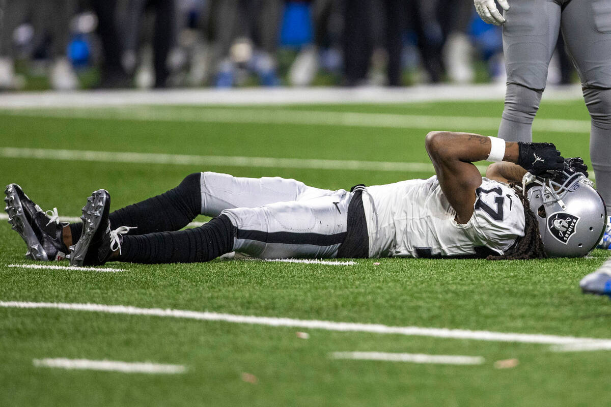 Raiders wide receiver Davante Adams (17) clutches his helmet after failing to make a catch agai ...