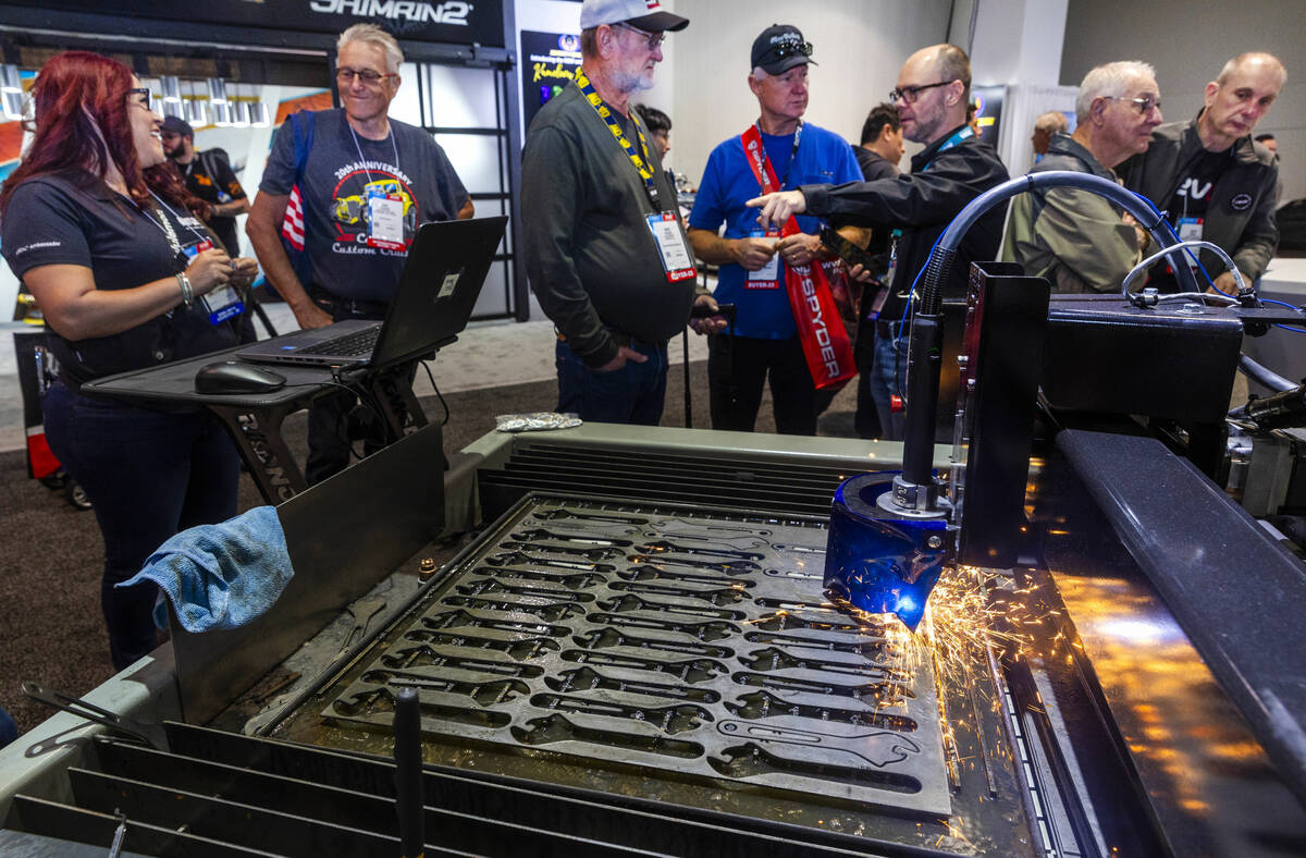 Attendees get a demonstration of a Radnor CNC Plasma Cutting Table during the first day of SEMA ...