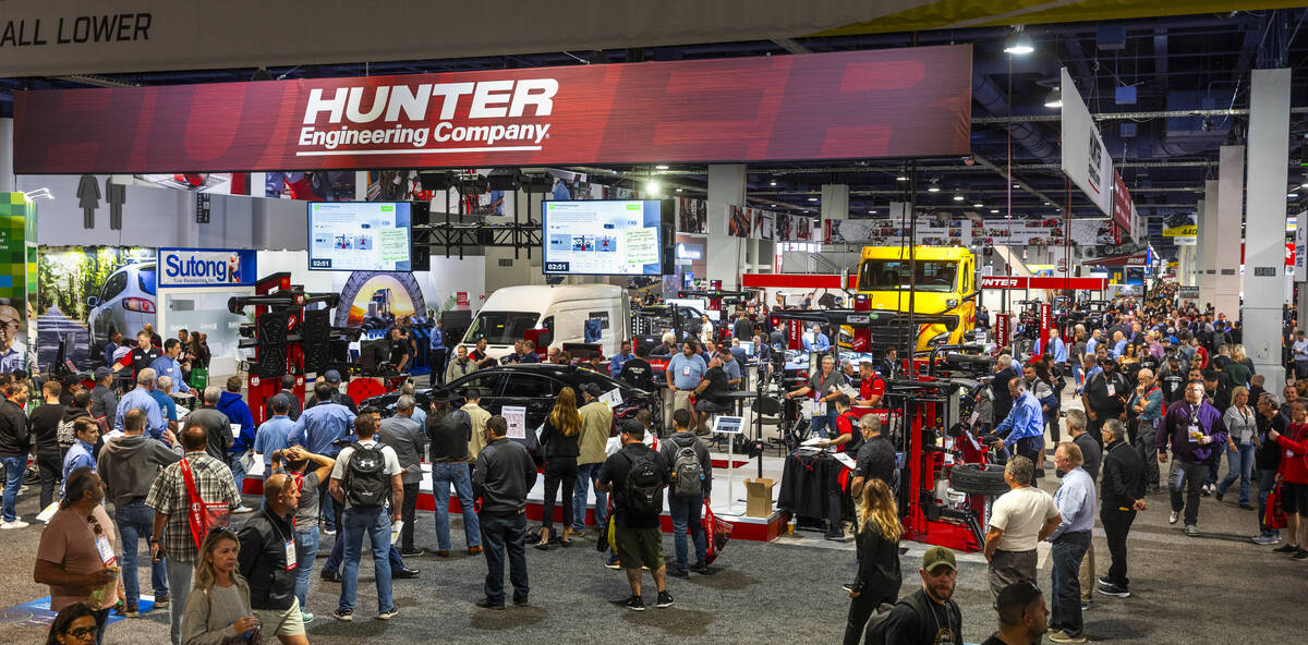 Attendees walk about and view some of the many vehicle maintenance machines by the Hunter Engin ...