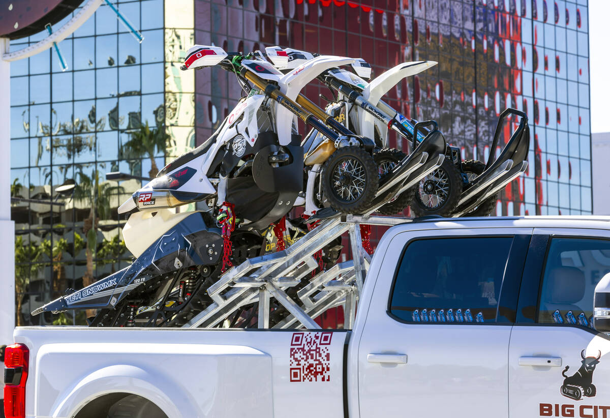 Snowmobiles are attached to a custom rack outside during the first day of SEMA at the Las Vegas ...