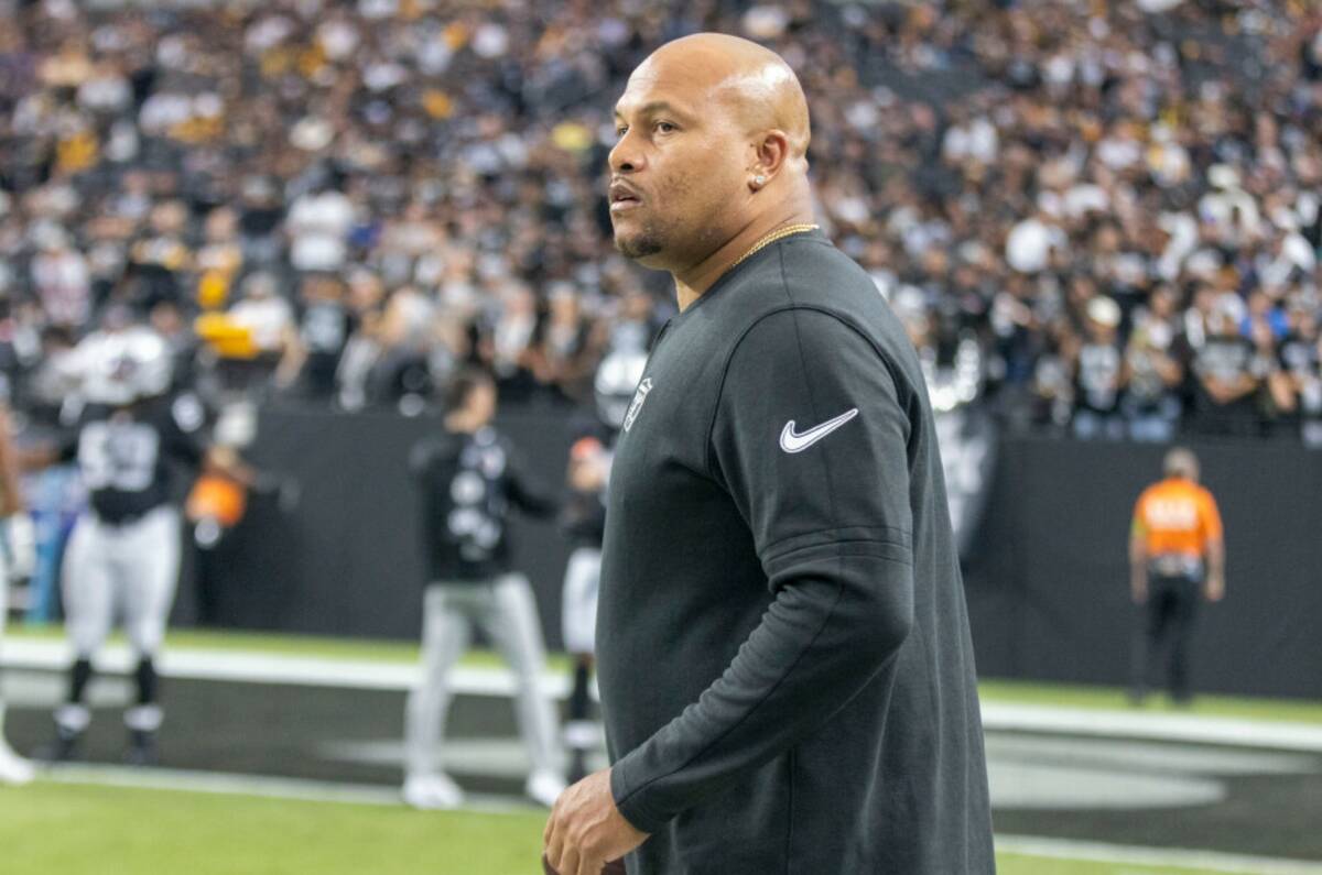 Raiders linebackers coach Antonio Pierce looks on from the sideline before an NFL game against ...