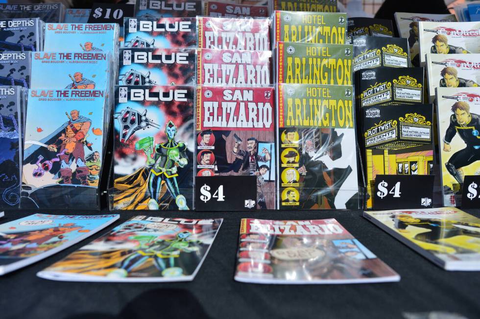 Comic books from Plot Twist Publishing, a Las Vegas based publisher, sit on display at the 11th ...