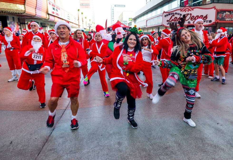 (LtoR) Ron and Dale Endo with Kelly Harris dance with others during the pre-race entertainment ...