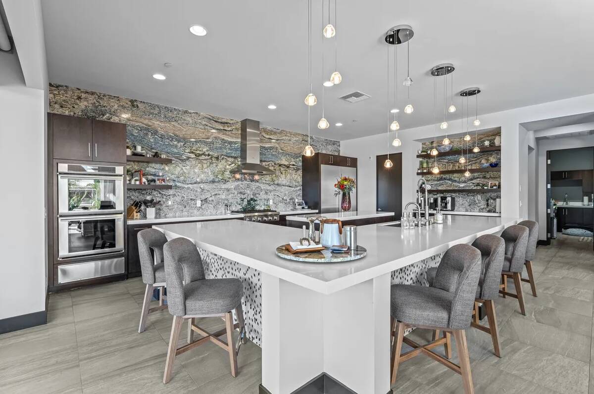 The residence boasts a gourmet kitchen illuminated by abundant light with a one-of-a-kind grani ...