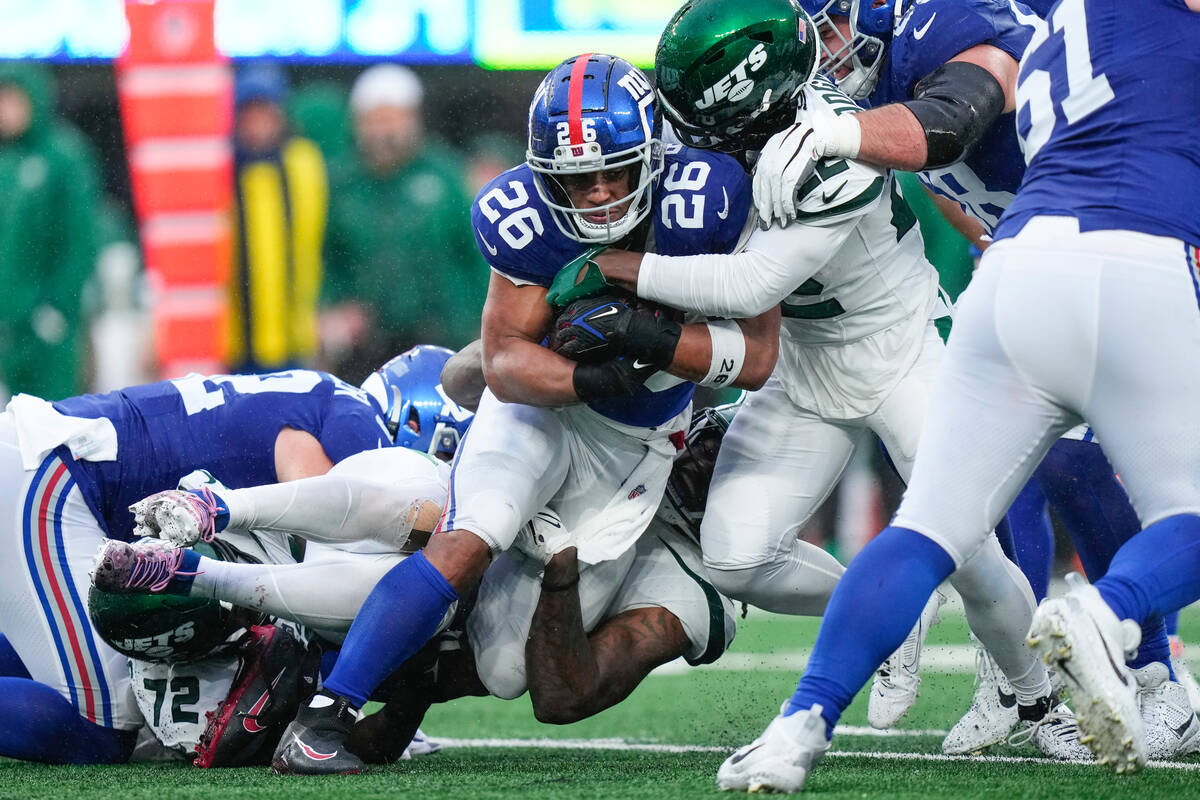 New York Giants running back Saquon Barkley (26) runs the ball during the second half of an NFL ...