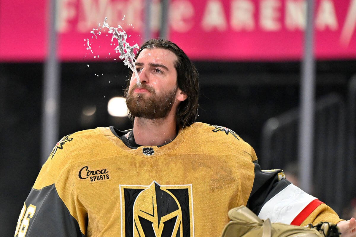 Vegas Golden Knights goaltender Logan Thompson spits out water before an NHL hockey game agains ...