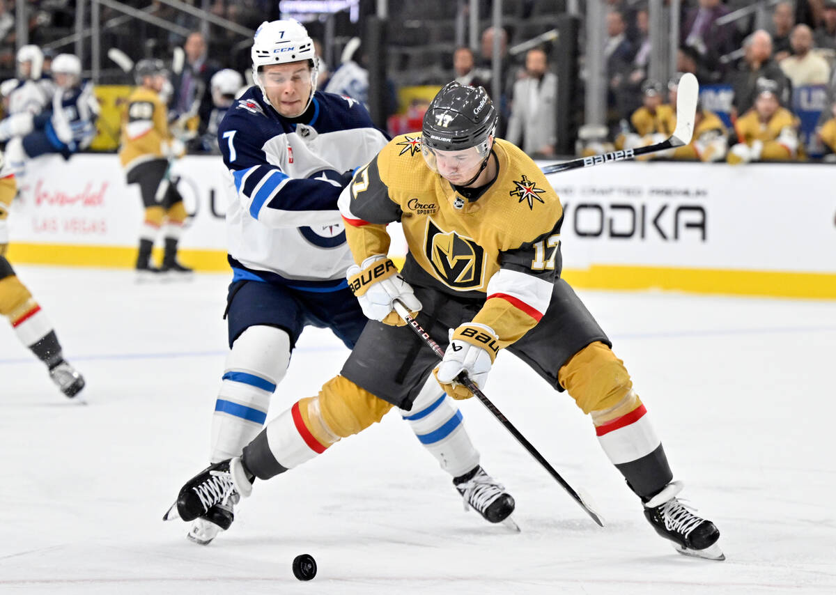 Vegas Golden Knights defenseman Ben Hutton (17) handles the puck against Winnipeg Jets center V ...