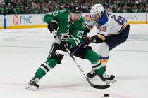 St. Louis Blues left wing Jake Neighbours, right, and Dallas Stars right wing Evgenii Dadonov, ...