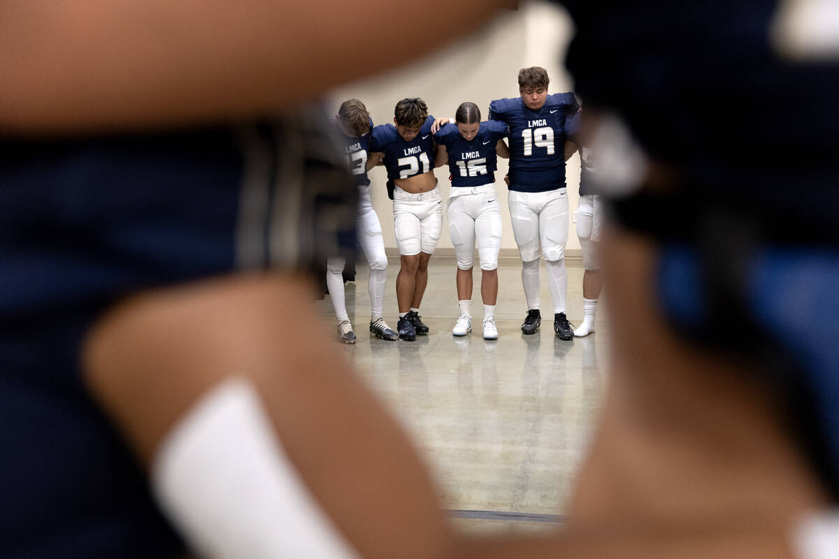 Lake Mead varsity football prays before their Class 2A high school football game against Lincol ...