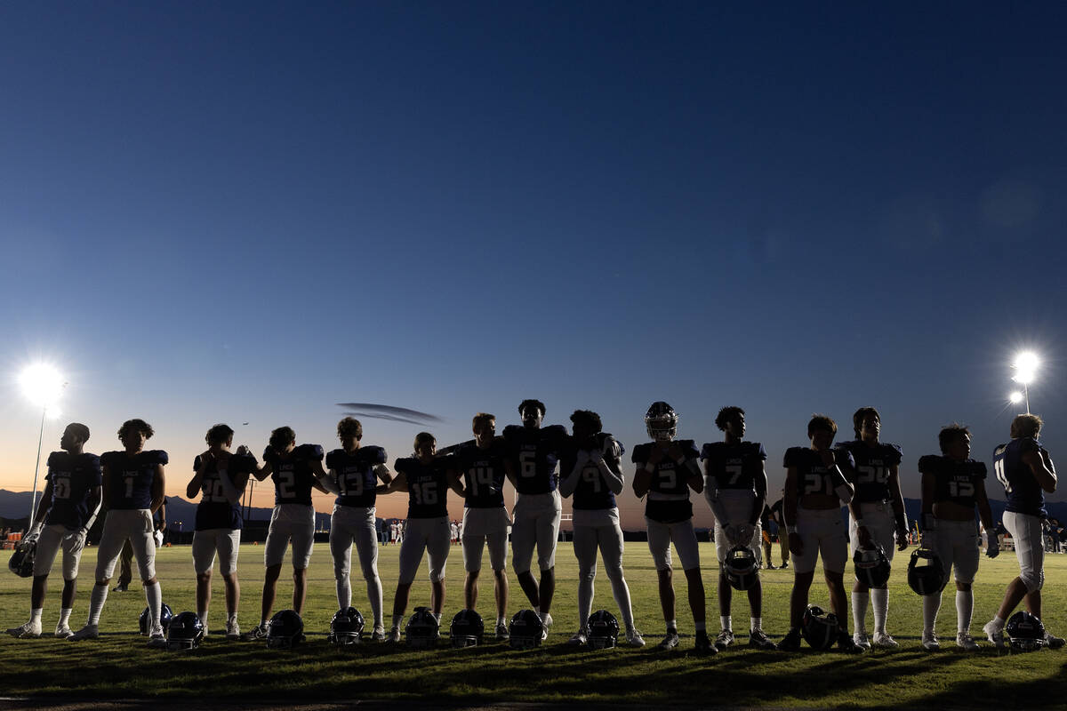 Lake Mead lines up for a prayer and the national anthem before their Class 2A high school footb ...