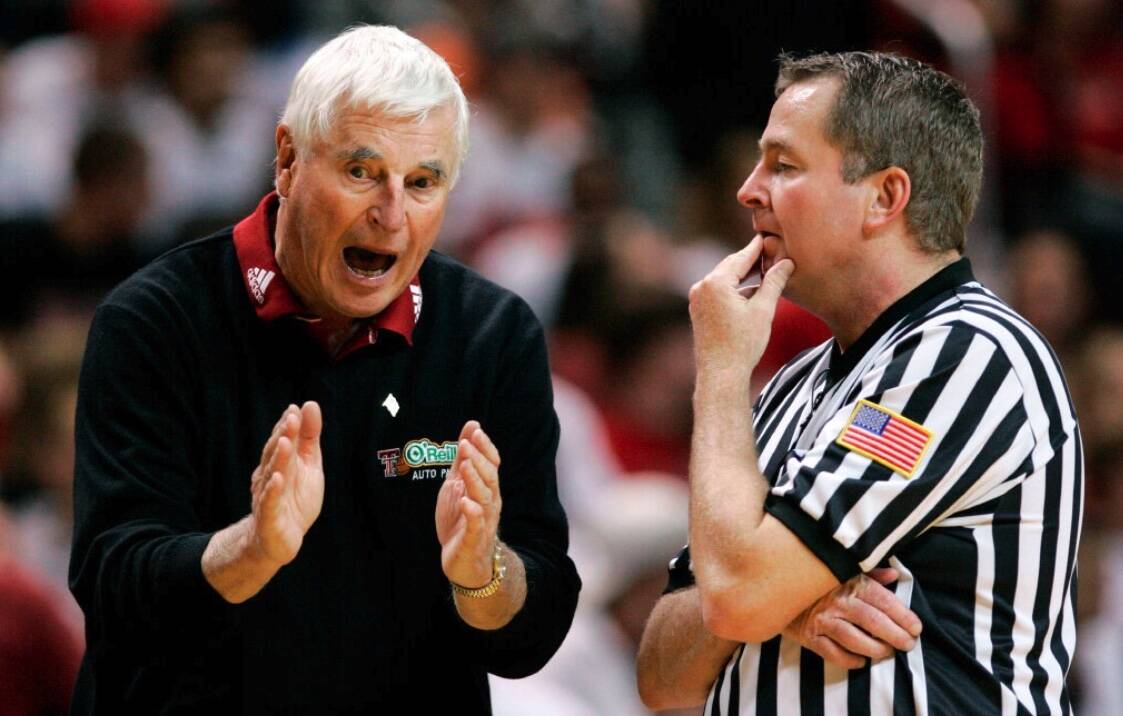 Texas Tech coach Bob Knight, left, argues a call with an NCAA official during a basketball game ...