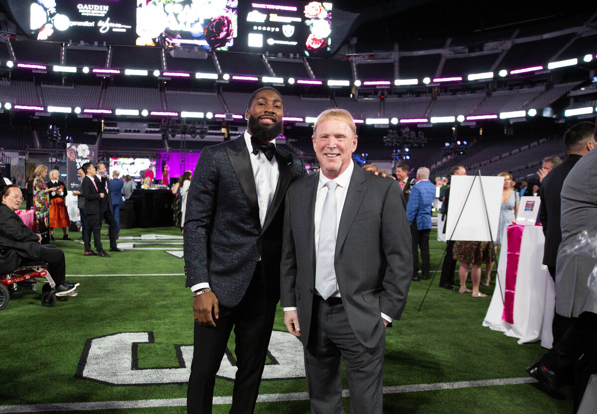Raiders cornerback Nate Hobbs and Raiders and Aces owner Mark Davis are shown at the Grant A Gi ...