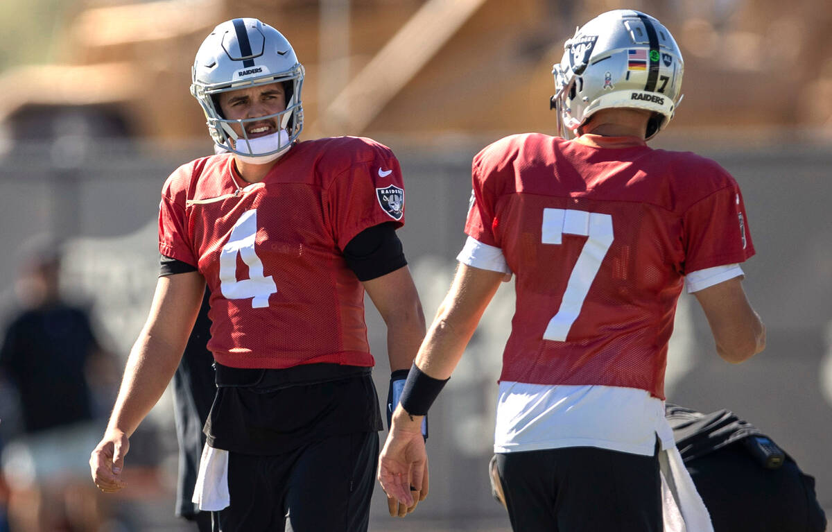 Raiders quarterback Aidan O'Connell (4) and quarterback Brian Hoyer (7) warm up during practice ...