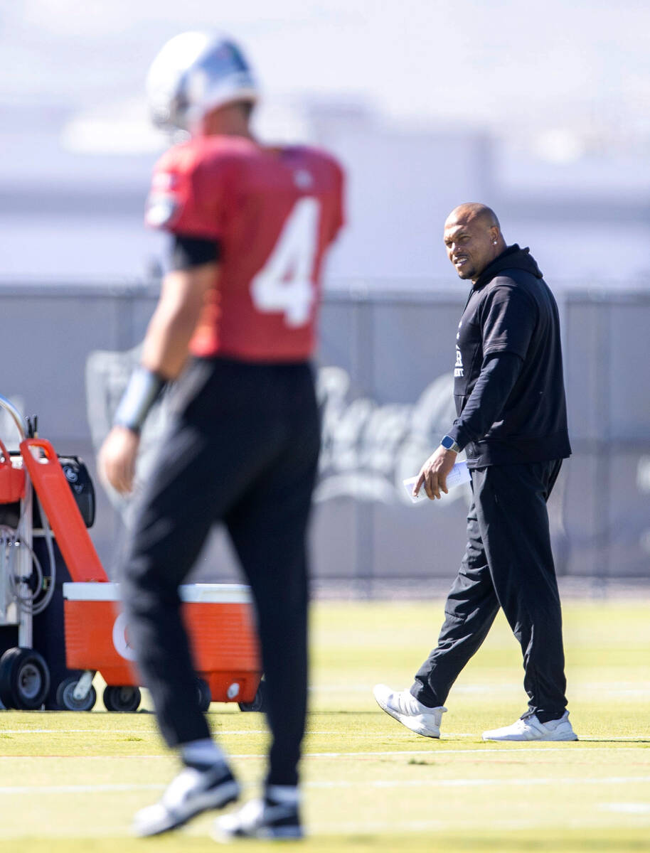 Raiders interim head coach Antonio Pierce looks on as quarterback Aidan O'Connell (4) warms up ...