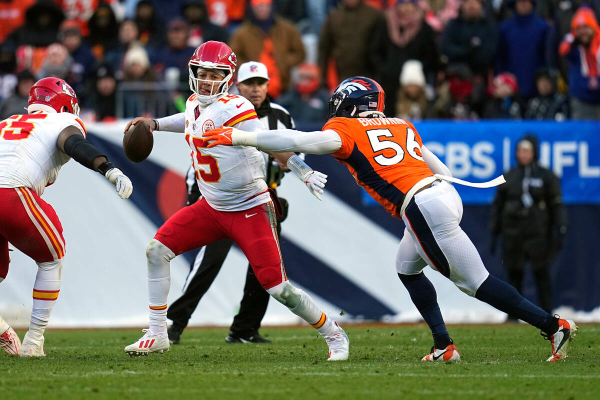 Kansas City Chiefs quarterback Patrick Mahomes scrambles away from Denver Broncos linebacker Ba ...