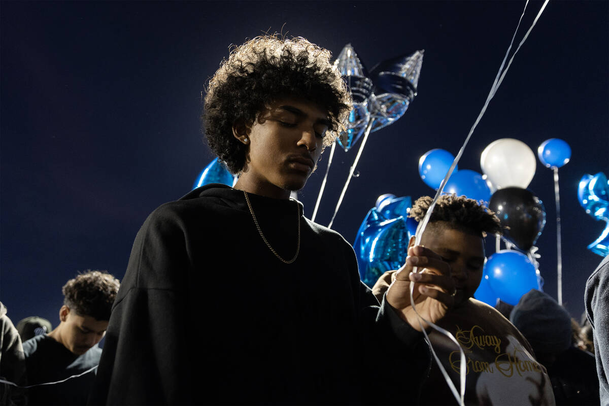 Malachi Barnes, 16, prays during a vigil for his friend Se’Mauri Norris-Johnson at All A ...