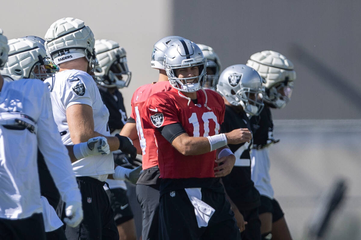 Raiders quarterback Jimmy Garoppolo (10) smiles while stretching during team practice at the In ...
