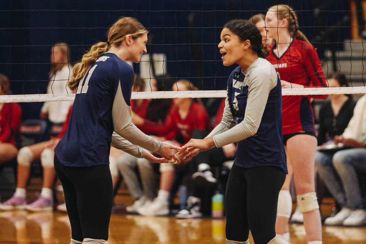 Shadow Ridge teammates Riah Thurston (11) and Desirae Noble (5) celebrate a point during a Clas ...