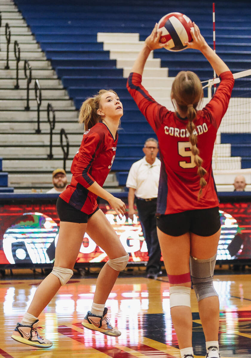 Coronado middle blocker Rachel Purser (9) watches her teammate Hannah Pemberton (5) hit the bal ...