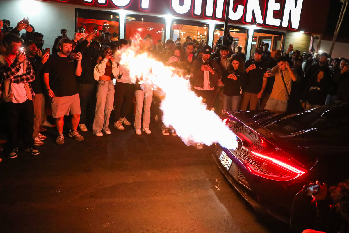 Sports car enthusiasts admire cars at The Vegas Meet car show, a separate SEMA event down the r ...