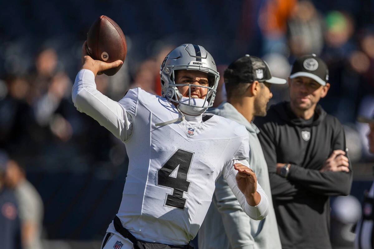 Raiders quarterback Aidan O'Connell (4) warms up before an NFL game against the Chicago Bears o ...