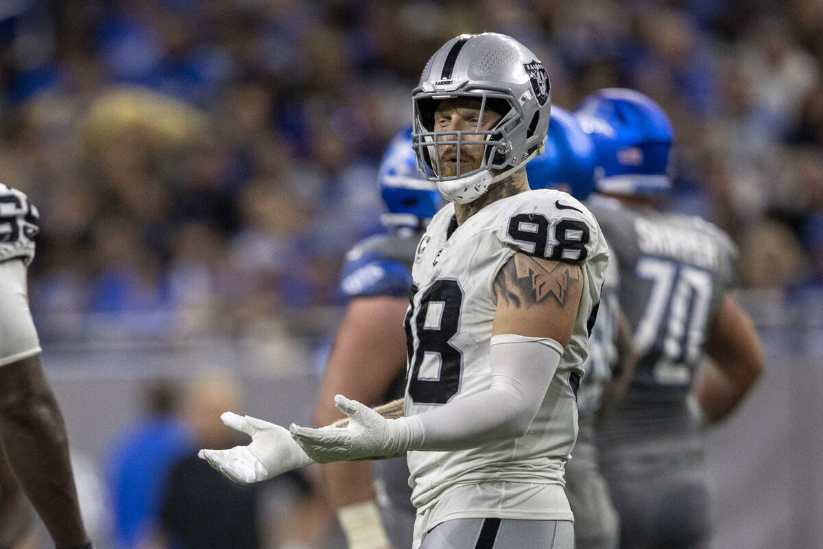 Raiders defensive end Maxx Crosby (98) reacts to being penalized on a fourth down play resultin ...