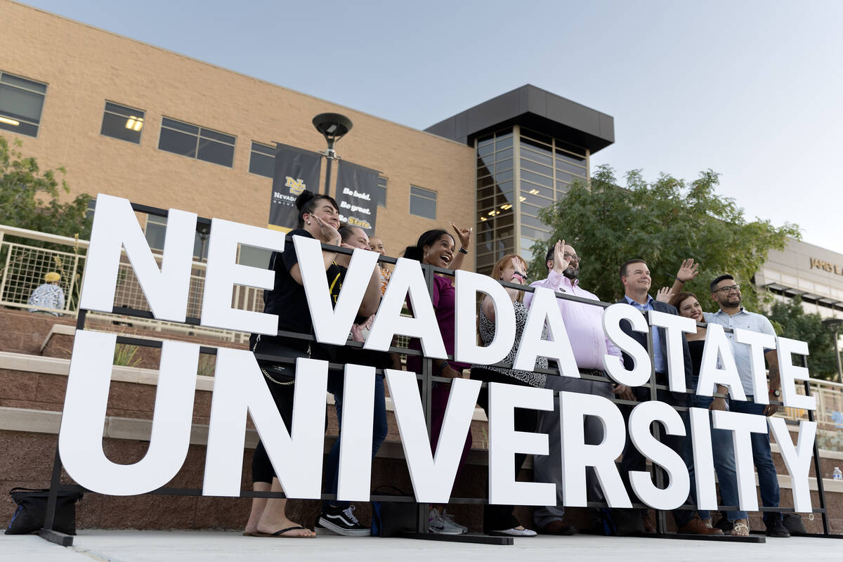 Alumni pose for photos in front of the new Nevada State University sign during a renaming celeb ...