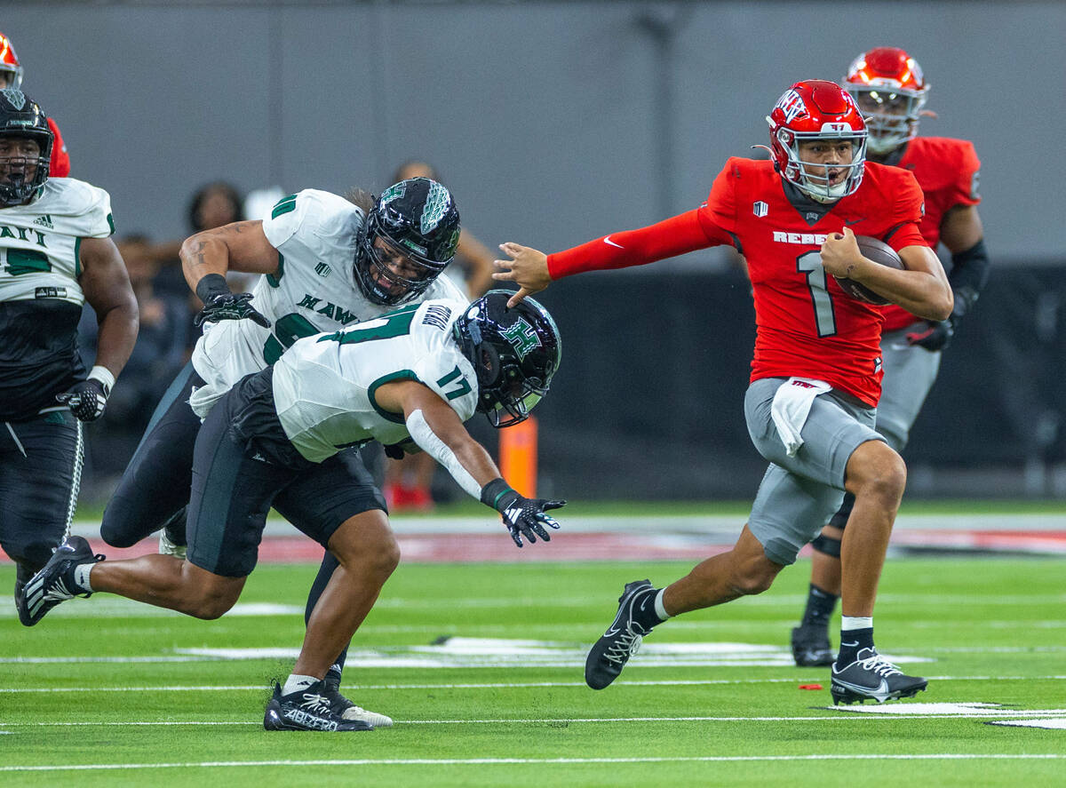 UNLV quarterback Jayden Maiava (1) runs upfield from Hawaii linebacker Isaiah Tufaga (17) durin ...