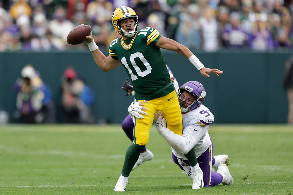 Green Bay Packers quarterback Jordan Love (10) passes the football Minnesota Vikings defensive ...
