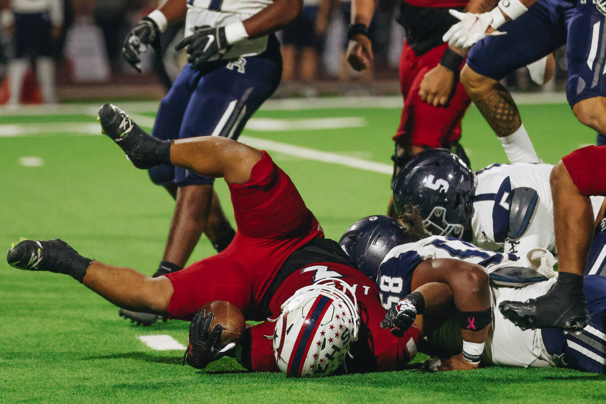 Liberty running back Isaiah Lauofo (3) falls onto the ground with the ball after a run during a ...