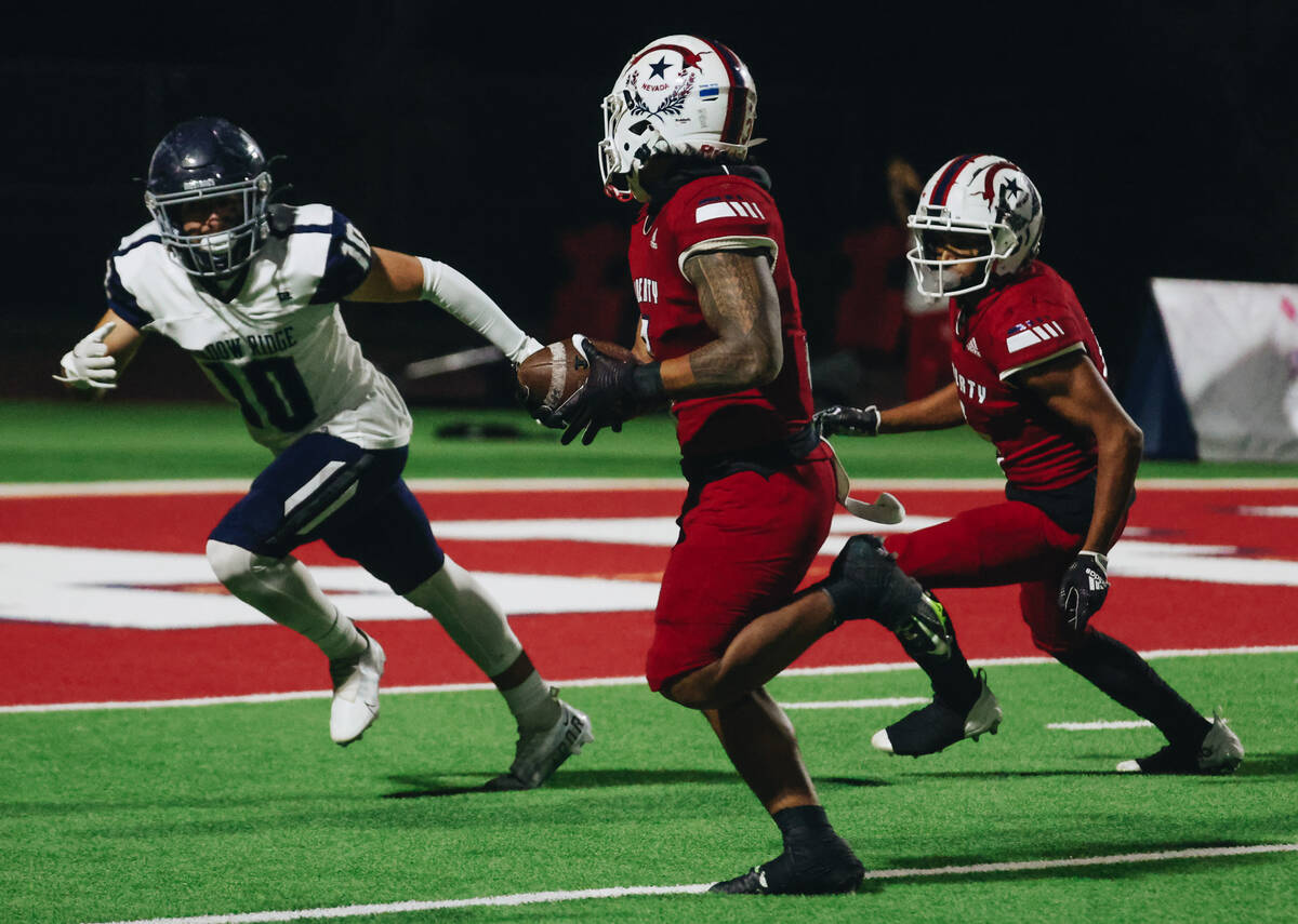 Liberty running back Isaiah Lauofo (3) runs the ball down to the end zone during a game against ...