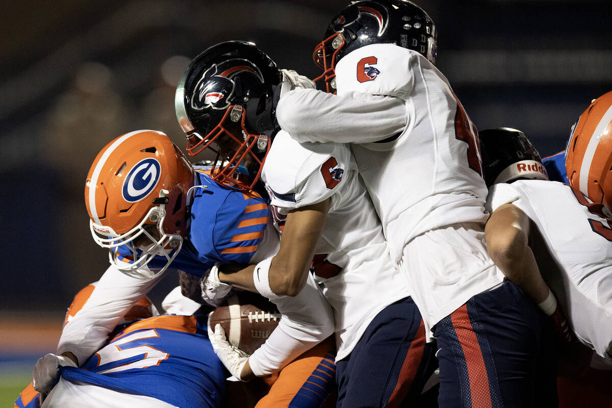 Bishop Gorman running back Devon Rice (3) is tackled by Coronado during the first half of a Cla ...