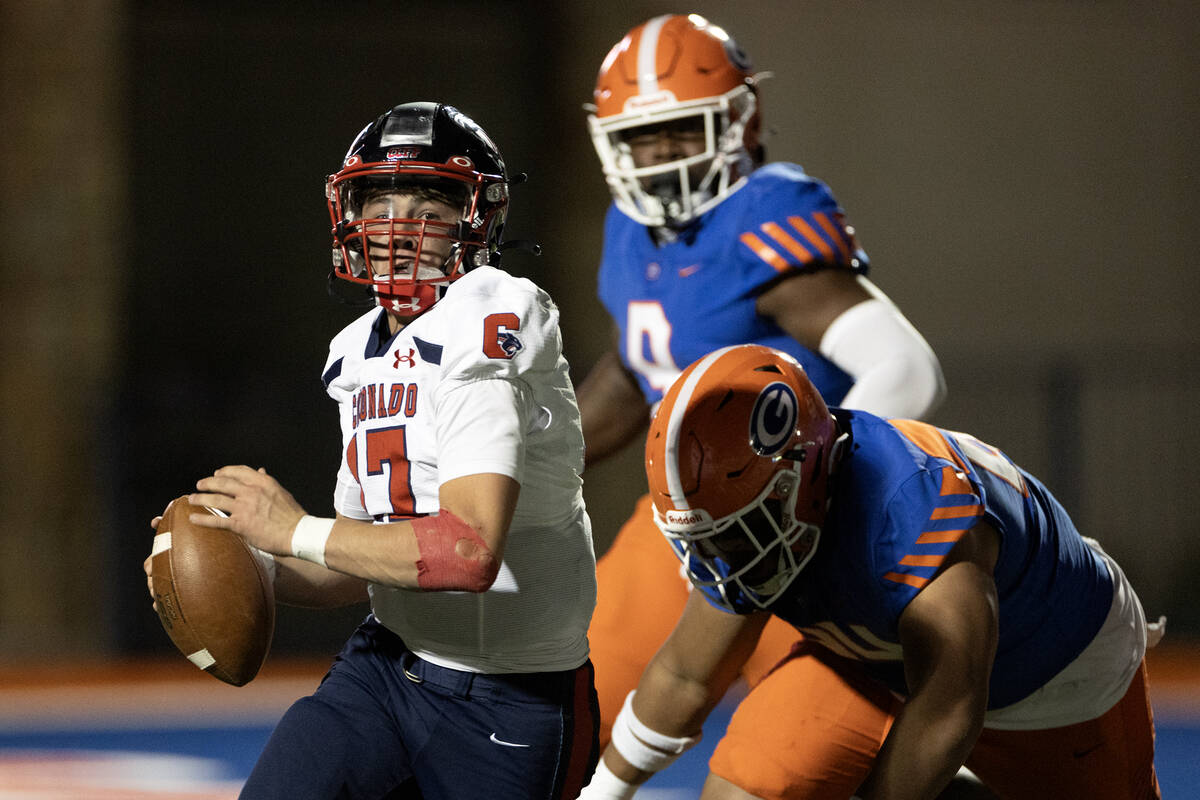 Coronado quarterback Jackson Humphries (17) looks to pass after evading a tackle by Bishop Gorm ...