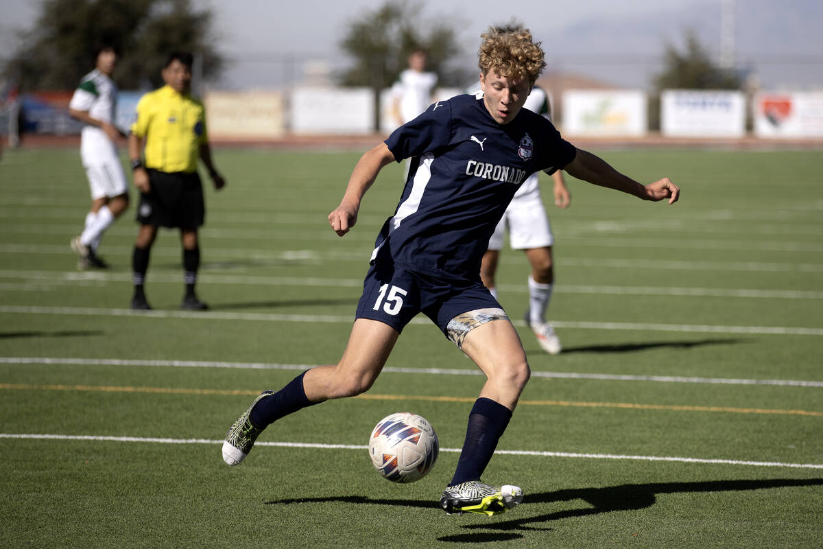 Coronado defender Ben Aronow (15) dribbles the ball away from the net during the first half of ...