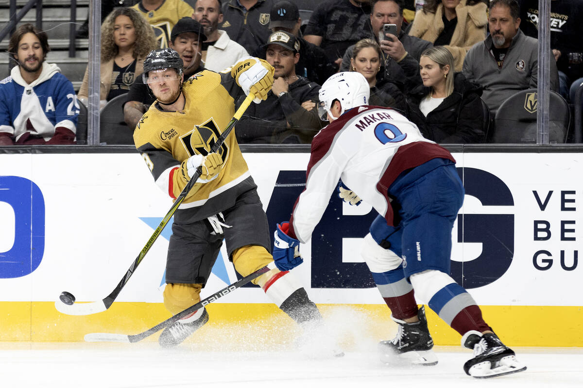 Golden Knights center Jack Eichel (9) passes the puck while Avalanche defenseman Cale Makar (8) ...