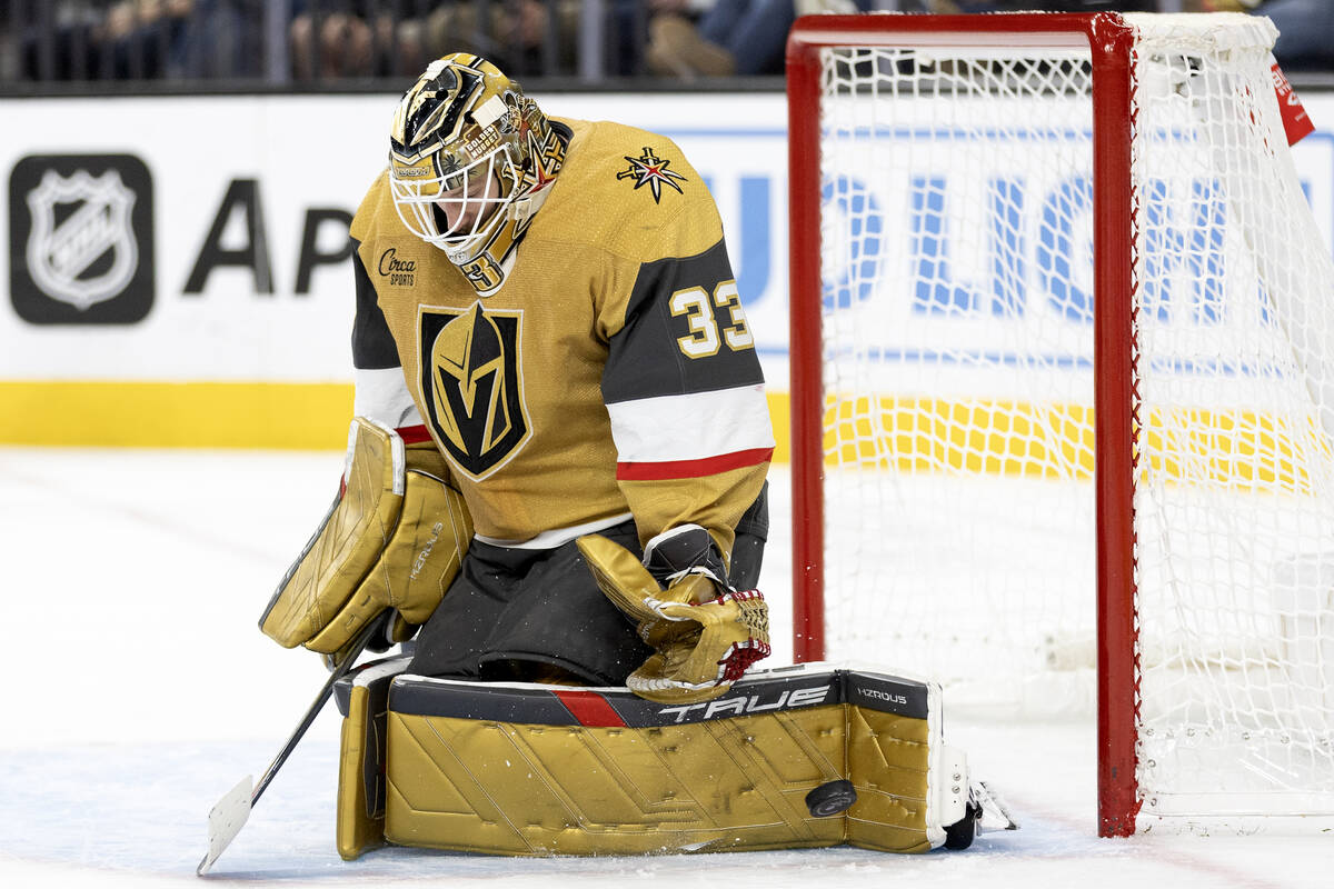 Golden Knights goaltender Adin Hill (33) saves the puck during the second period of an NHL hock ...