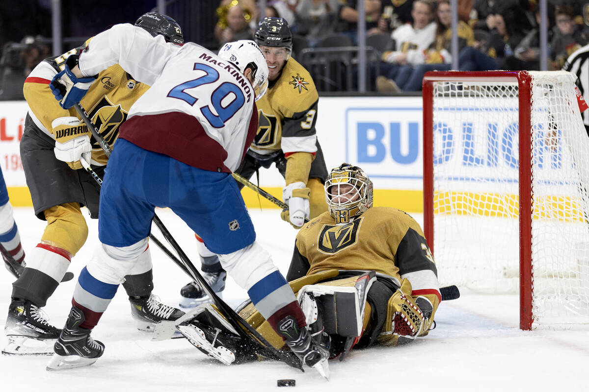 Golden Knights goaltender Adin Hill (33) eyes the puck, still in play, after saving a shot by A ...