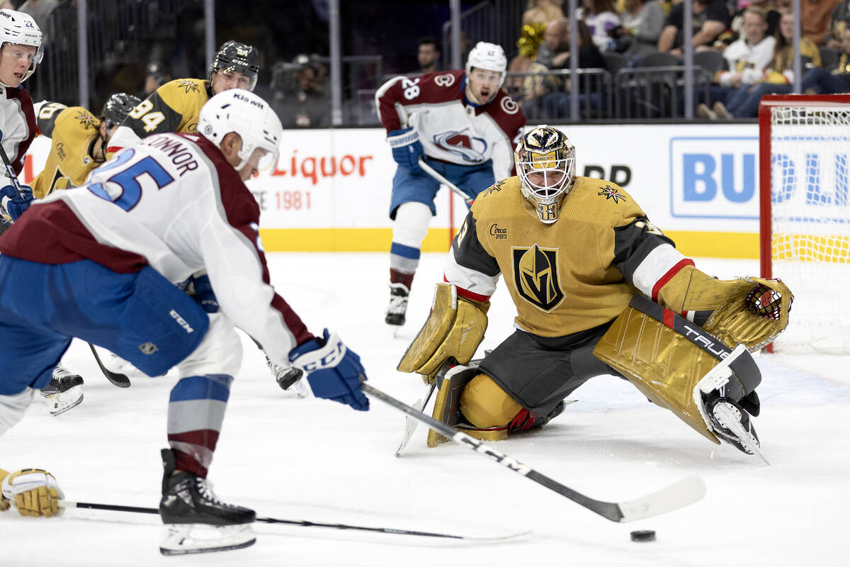 Golden Knights goaltender Adin Hill (33) prepares to save while Avalanche right wing Logan O'Co ...