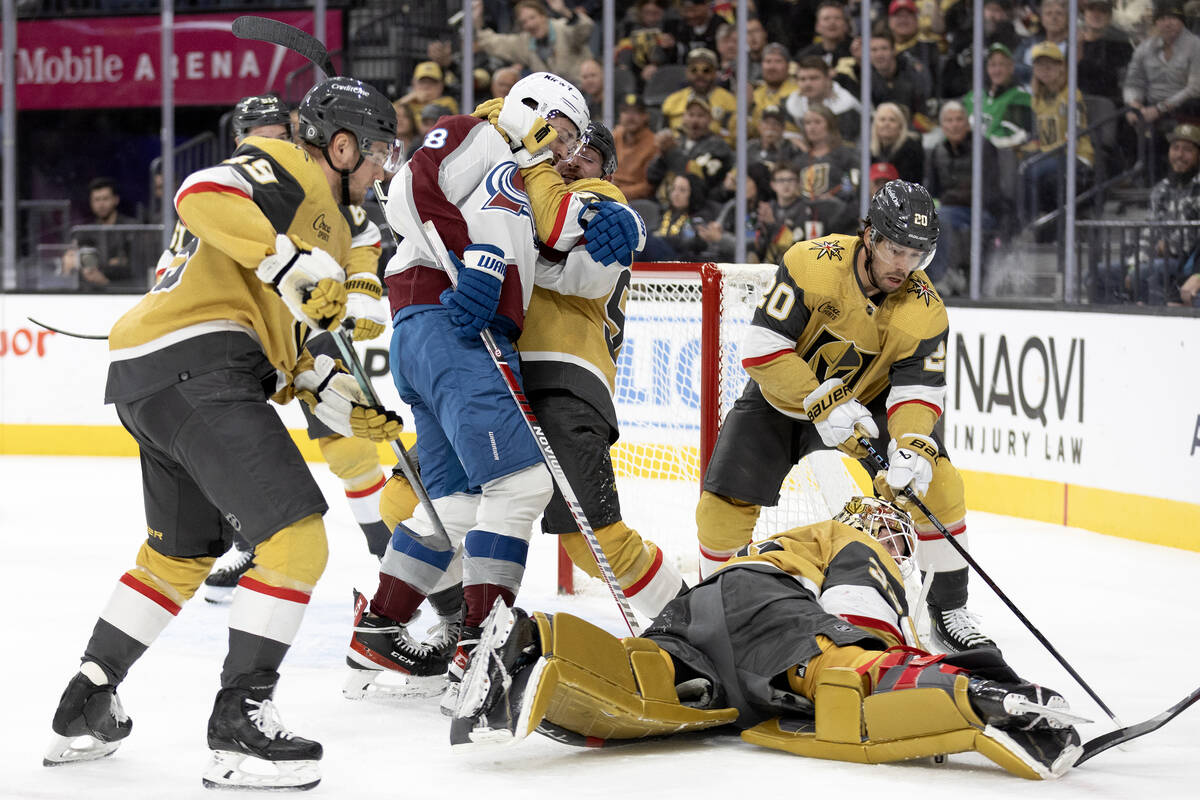 Golden Knights defenseman Brayden Pachal (94) and Avalanche left wing Miles Wood (28) tangle wh ...