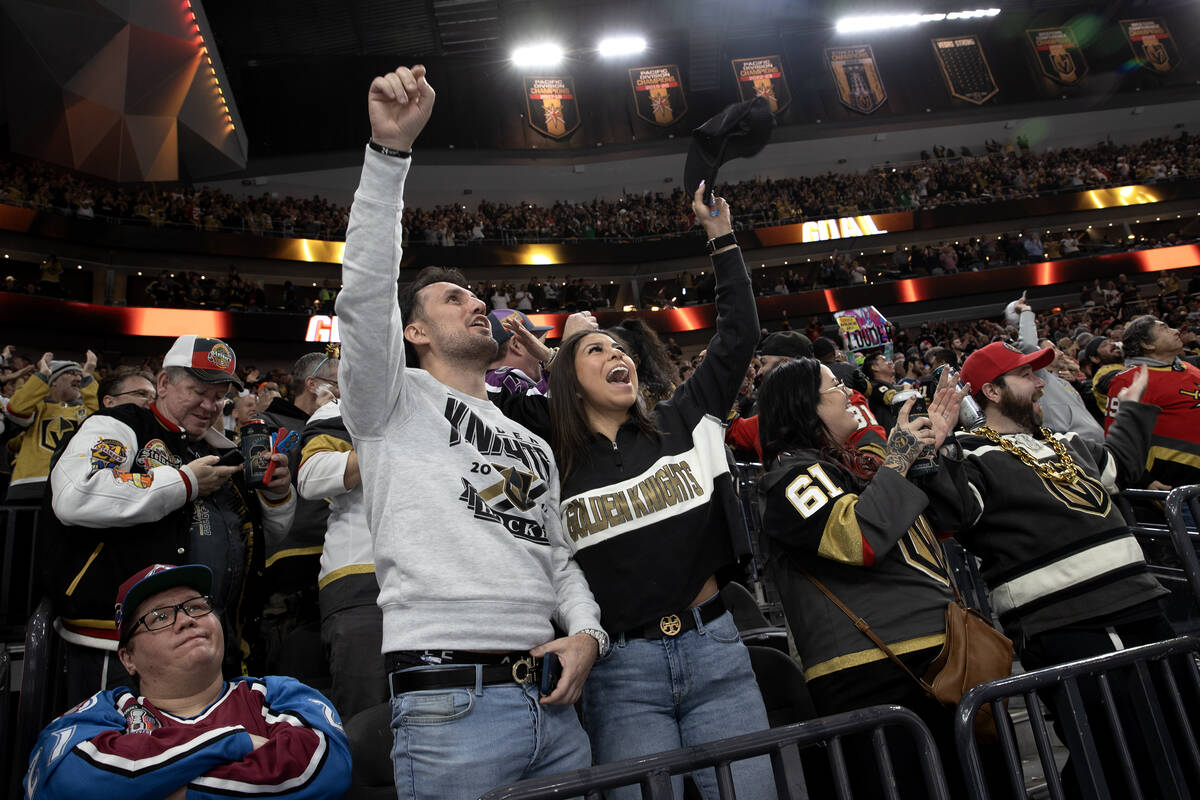 Golden Knights fans celebrate a goal while an Avalanche fan, left, reacts during the second per ...