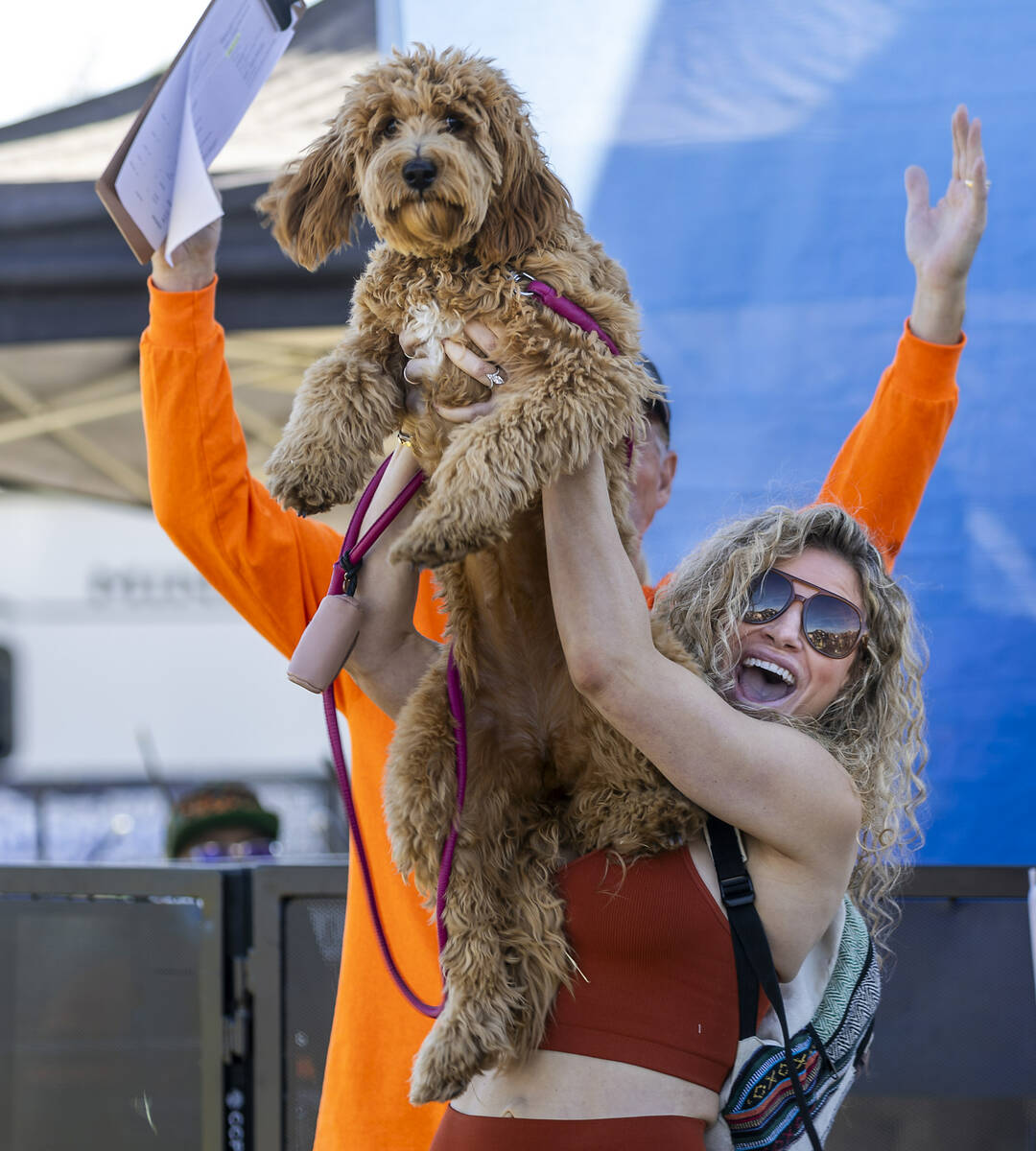 Sarah Starr holds her dog Hazel up high as she celebrates their owner/dog look-alike contest wi ...