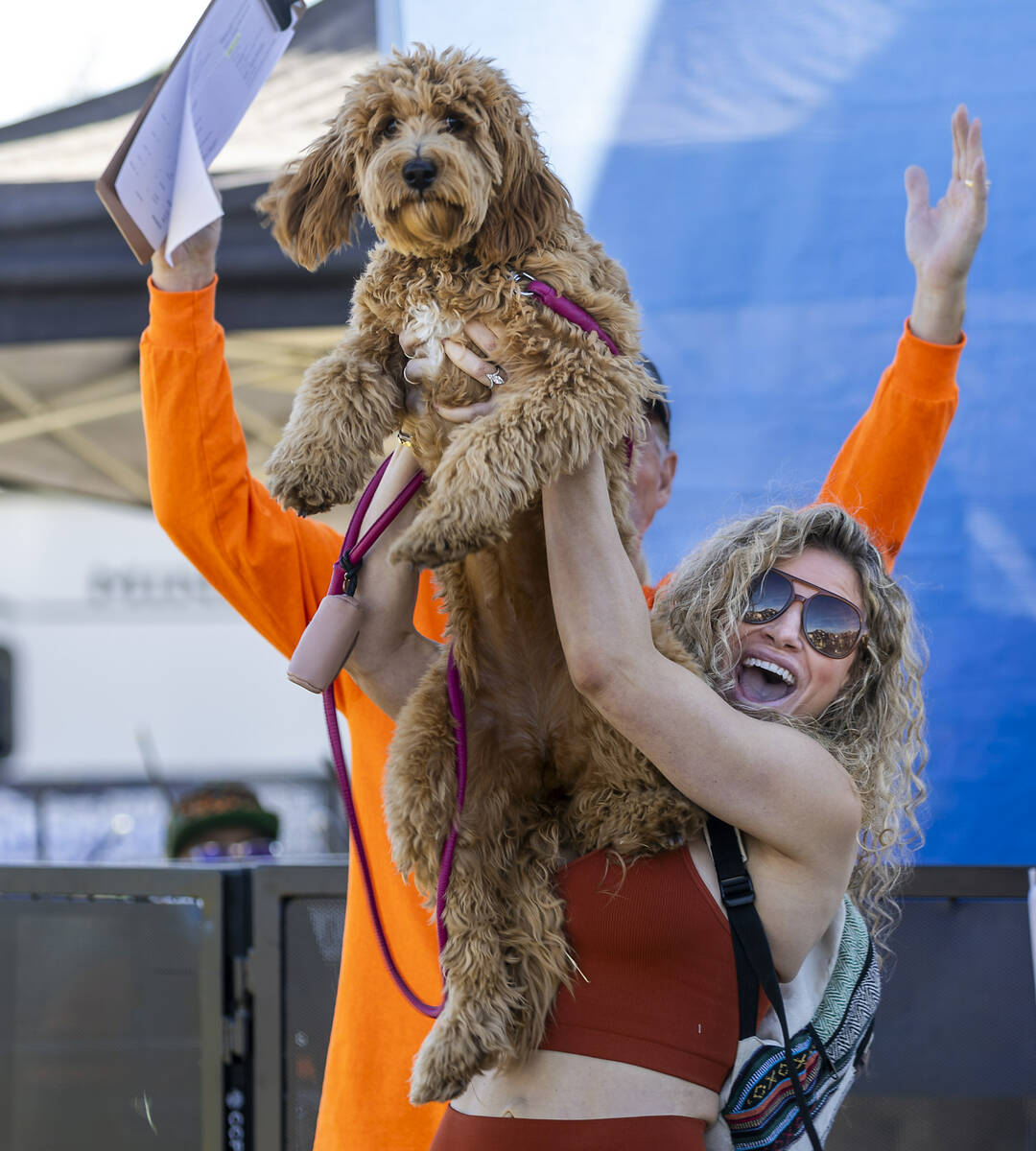 Sarah Starr holds her dog Hazel up high as she celebrates their owner/dog look-alike contest wi ...
