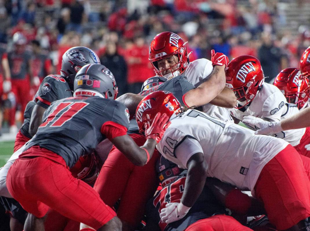 UNLV quarterback Cameron Friel, top center, follows his line into in end zone for a touchdown a ...
